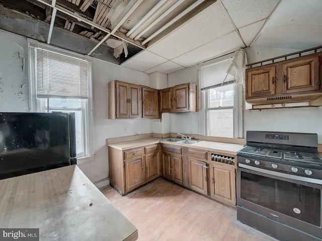 a kitchen with stainless steel appliances granite countertop a stove and a microwave