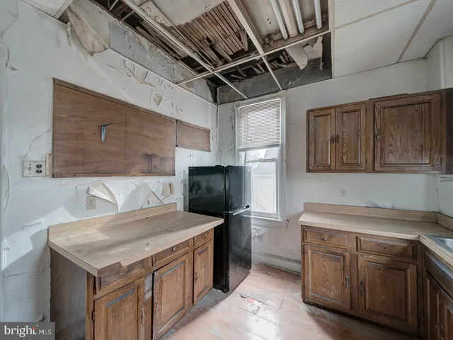 a kitchen with a stove sink and cabinets