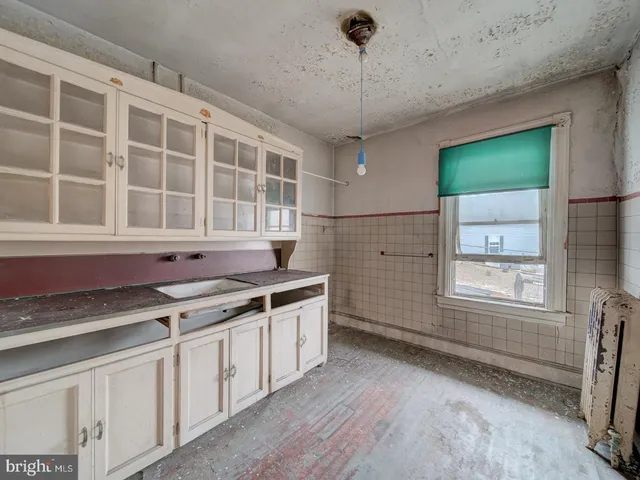 a kitchen with stainless steel appliances a sink stove and cabinets