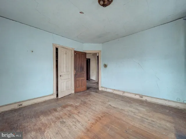 a view of an empty room and a window