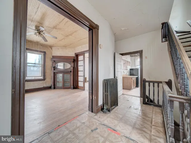 an empty room with windows and entryway