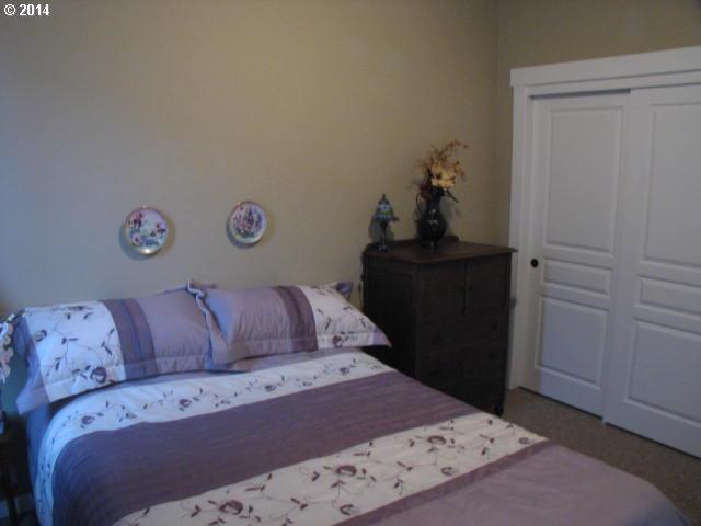 3702 North 3rd Circle Ridgefield, WA 98642 - Photo 12 of 16 a bedroom with a bed and cabinet