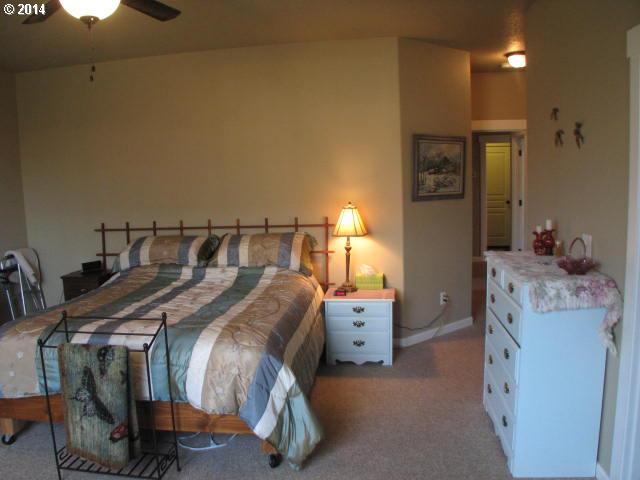 3702 North 3rd Circle Ridgefield, WA 98642 - Photo 13 of 16 a bed sitting in a bedroom next to a window