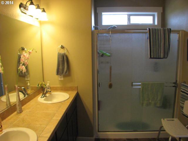 3702 North 3rd Circle Ridgefield, WA 98642 - Photo 14 of 16 a bathroom with a granite countertop shower sink and mirror