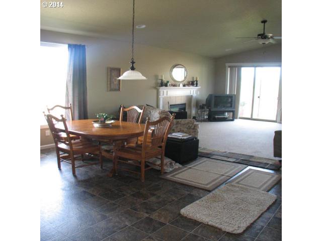 3702 North 3rd Circle Ridgefield, WA 98642 - Photo 5 of 16 a living room with furniture a lamp and a dining table