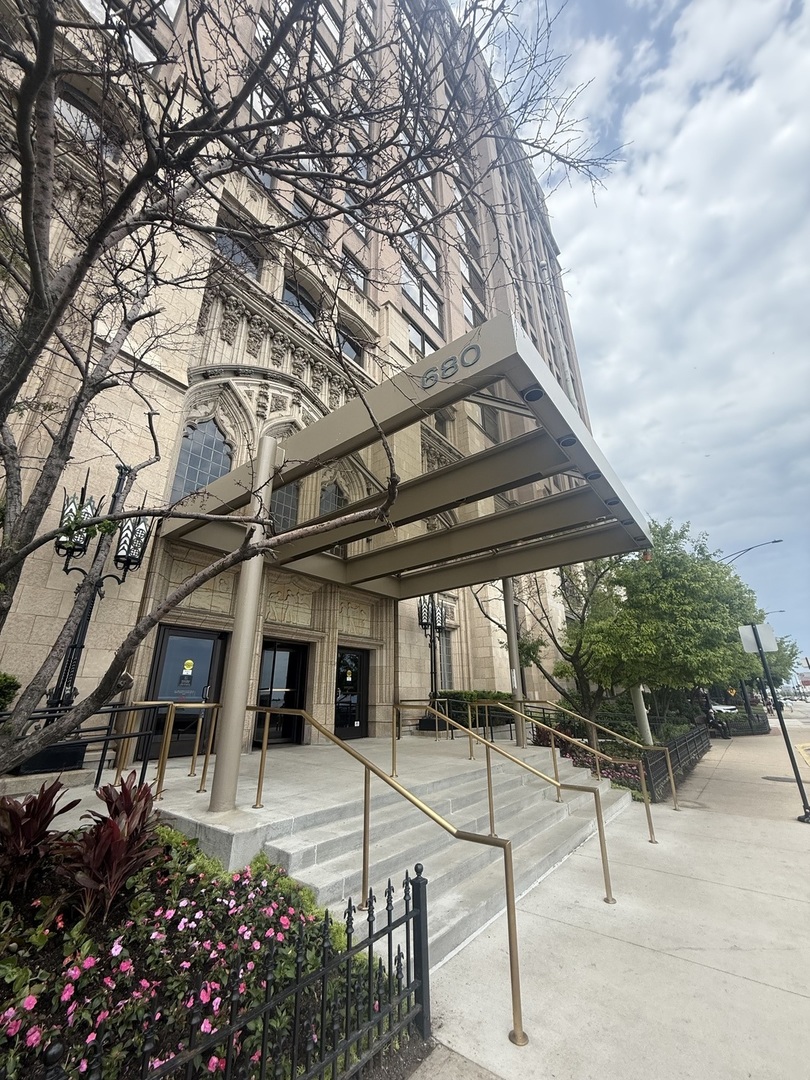 a view of a patio with a table and chairs and potted plants
