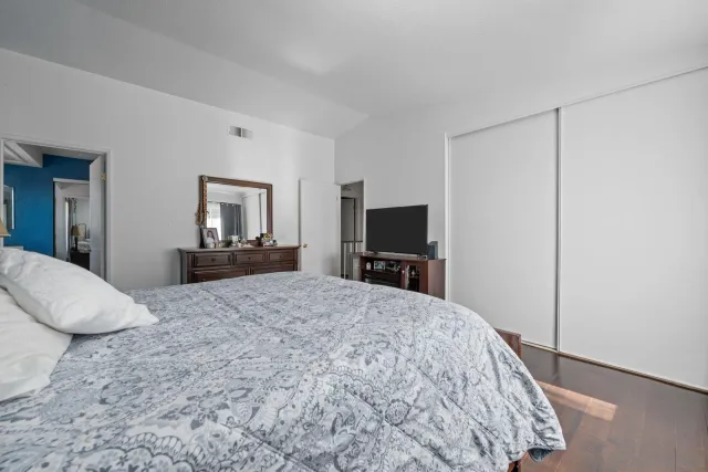 a bedroom with a bed and a flat screen tv