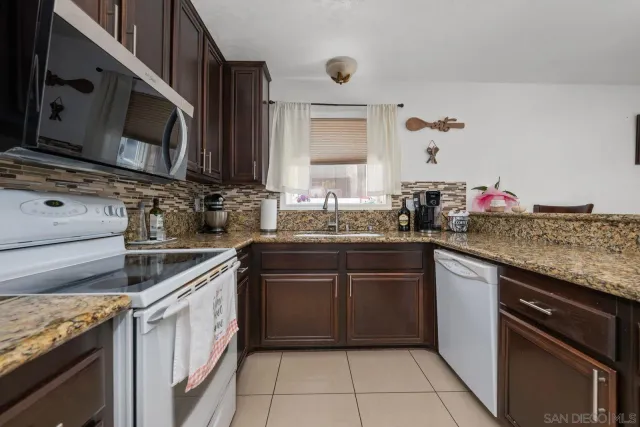 a kitchen with a sink and a stove top oven