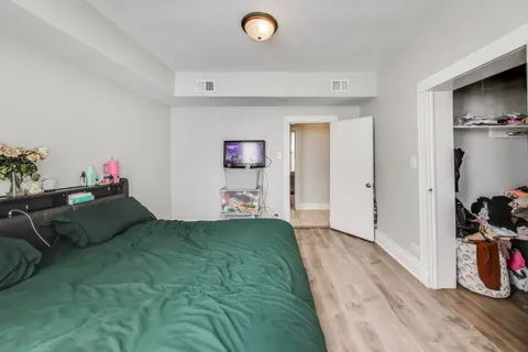 a bed room with a bed and a television