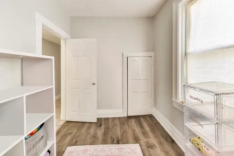 a view of hallway with wooden floor and fence