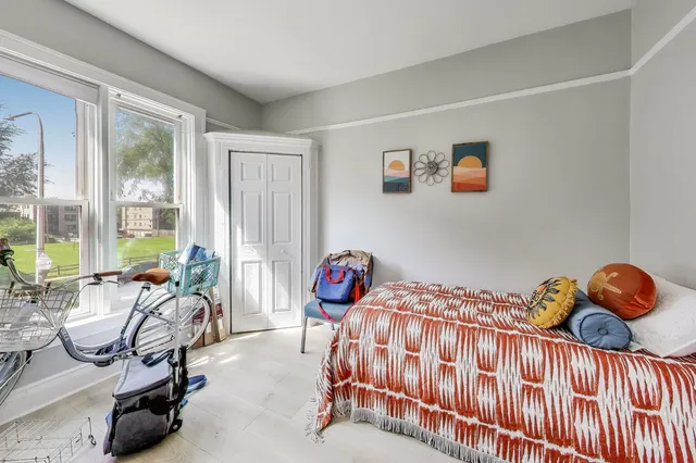 a bedroom with a bed and a chair