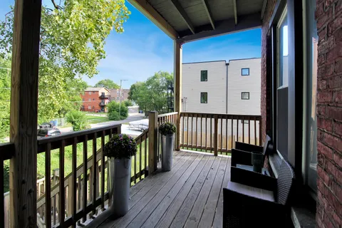 a view of a balcony with two large trees