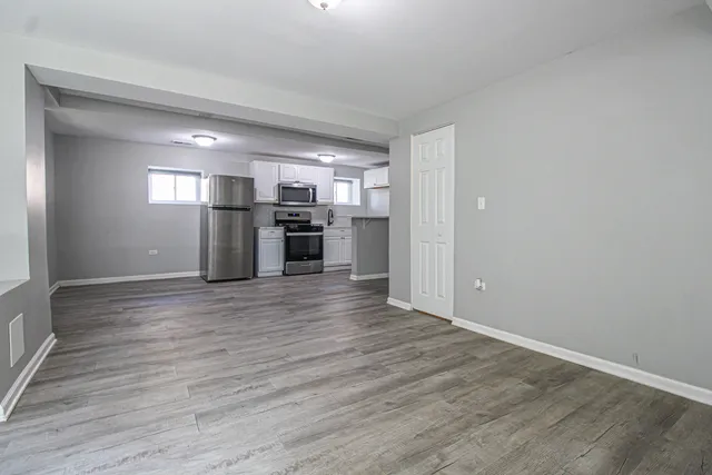 a kitchen with stainless steel appliances granite countertop a refrigerator microwave and sink