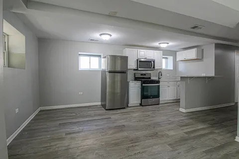 a kitchen with a sink and steel appliances
