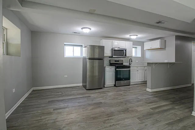 a kitchen with a sink and steel appliances