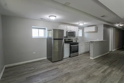a kitchen with a stove a sink and a refrigerator