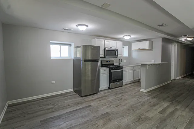 a kitchen with a stove a sink and a refrigerator