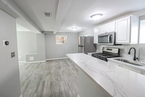 a bathroom with a sink vanity granite and shower