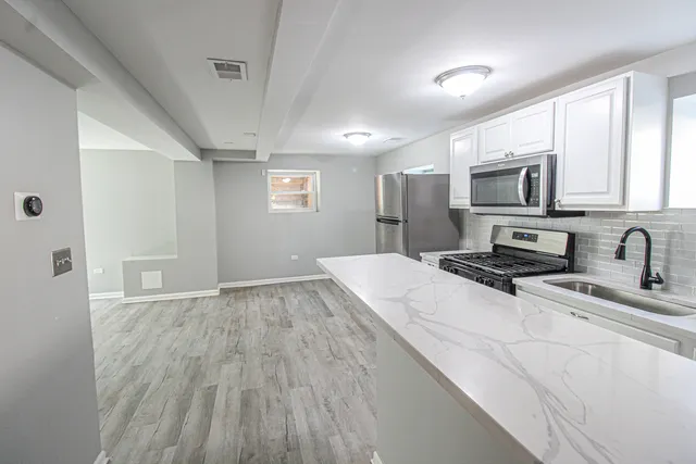 a bathroom with a sink vanity granite and shower
