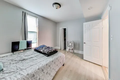 a bedroom with a bed and a window