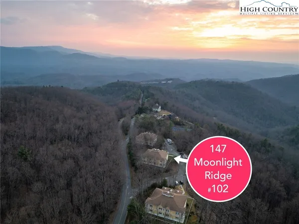a view of a house with a swimming pool and a yard