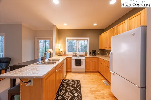 a kitchen with stainless steel appliances a table and chairs