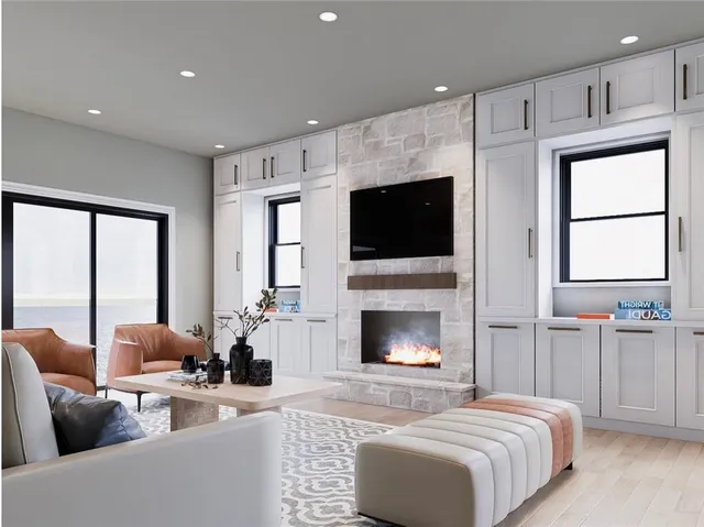 a living room with furniture a flat screen tv and a fireplace