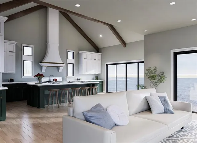 a living room with large couches bookshelf and a large window