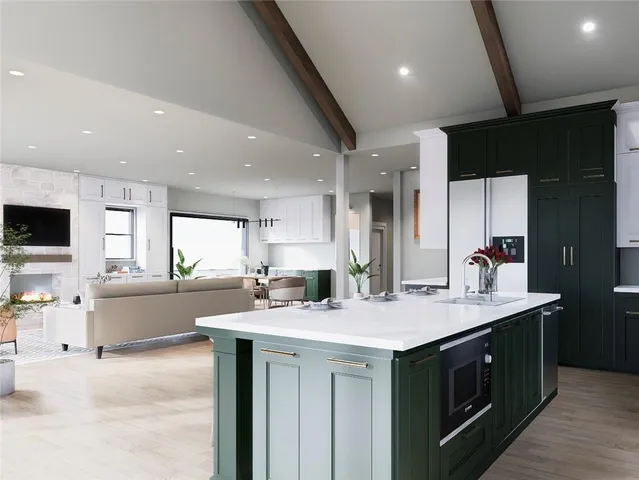 a kitchen with a sink and a stove top oven with wooden floor
