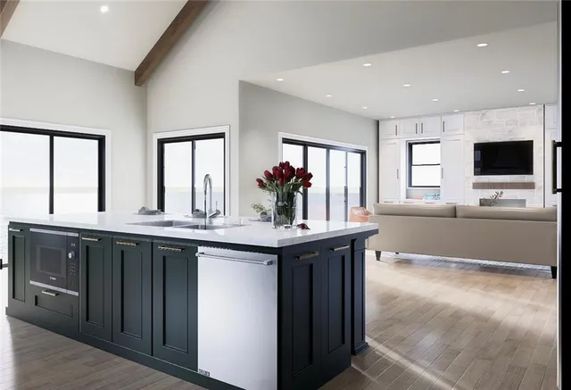 a kitchen with stainless steel appliances granite countertop a sink and a stove