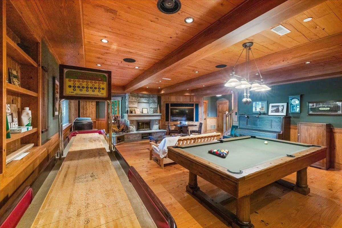 3231 Wolf Lake Road Ely, MN 55731 - Photo 30 of 50 Recreation room featuring light hardwood / wood-style flooring, beamed ceiling, pool table, a stone fireplace, and wood ceiling