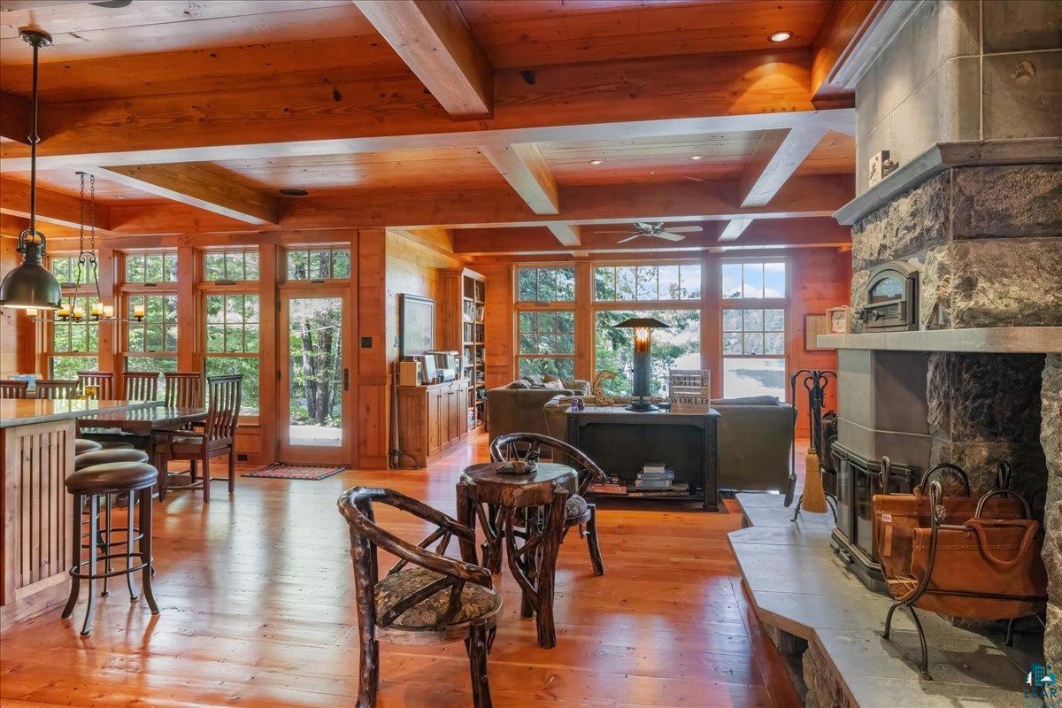 3231 Wolf Lake Road Ely, MN 55731 - Photo 7 of 50 Interior space with coffered ceiling, a fireplace, ceiling fan, beam ceiling, and wood-type flooring
