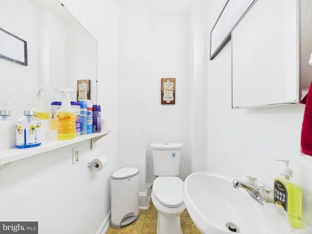 a bathroom with a sink toilet and mirror