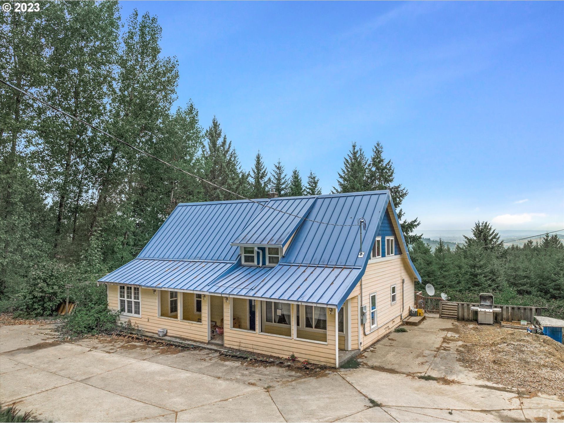 6160 Northwest Kiacut Road Gaston, OR 97119 - Photo 15 of 18 a view of a house with a yard and sitting area