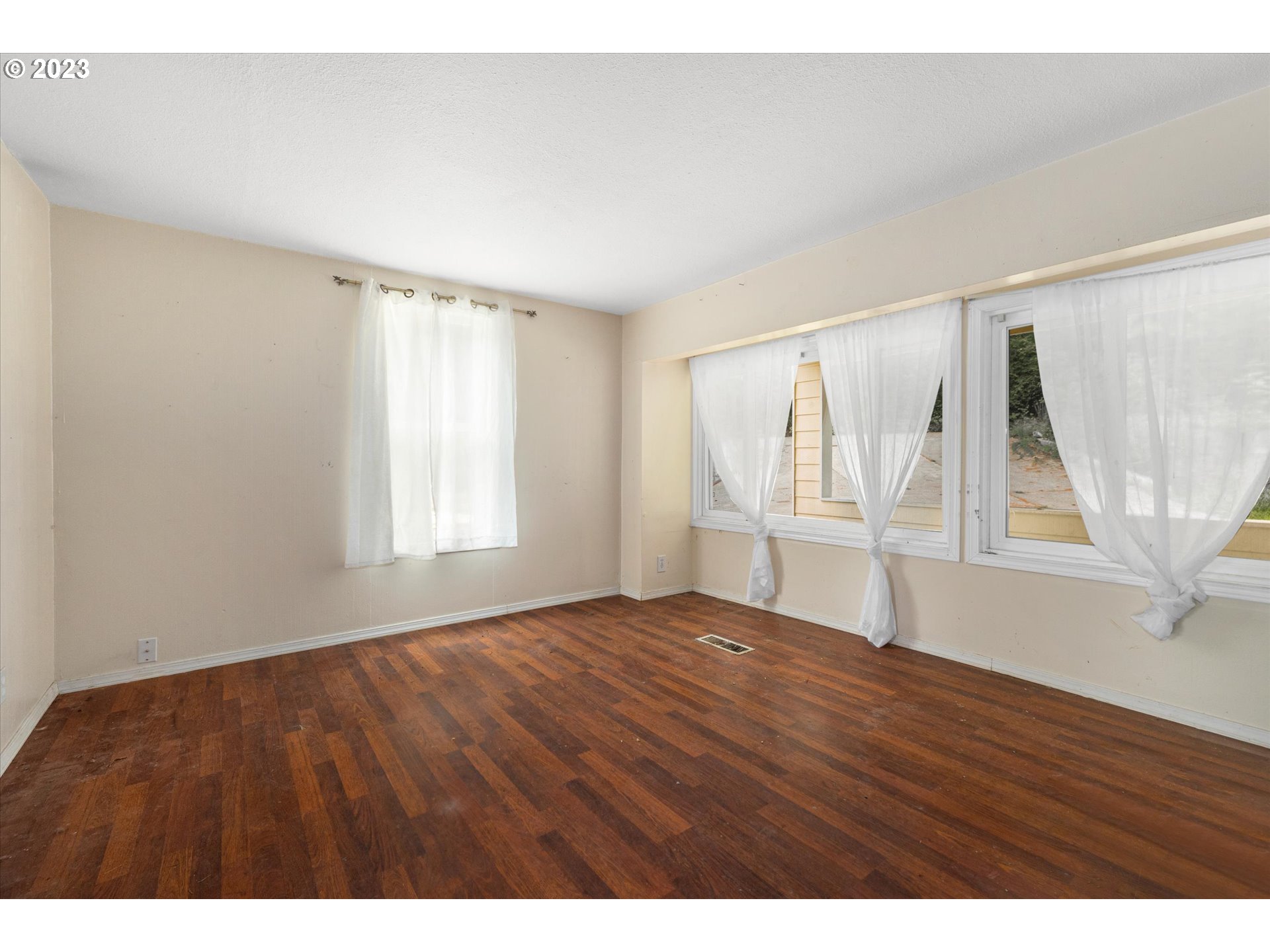 6160 Northwest Kiacut Road Gaston, OR 97119 - Photo 4 of 18 a view of an empty room with wooden floor and fan