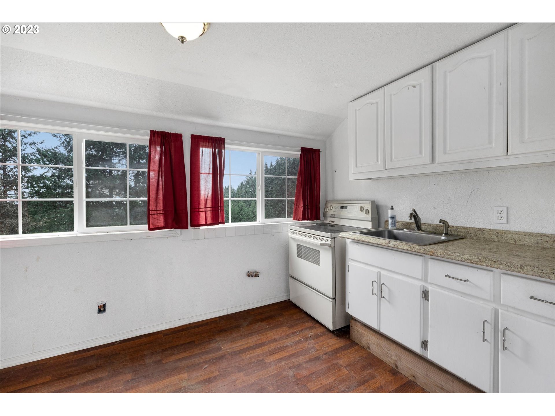 6160 Northwest Kiacut Road Gaston, OR 97119 - Photo 6 of 18 a kitchen with granite countertop white cabinets and sink