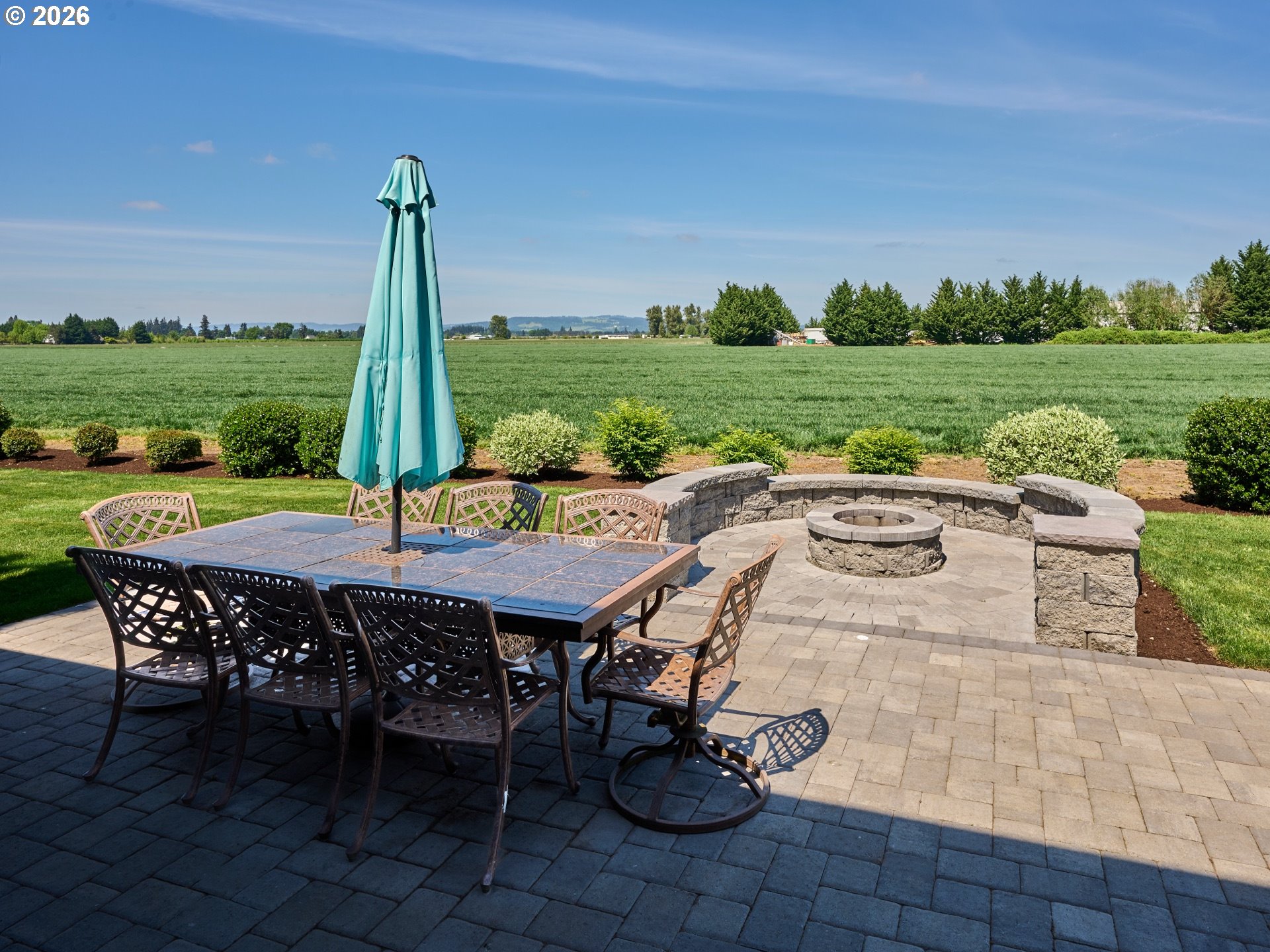 9293 Broadacres Road Northeast Aurora, OR 97002 - Photo 32 of 48 a view of a patio with table and chairs potted plants and palm trees