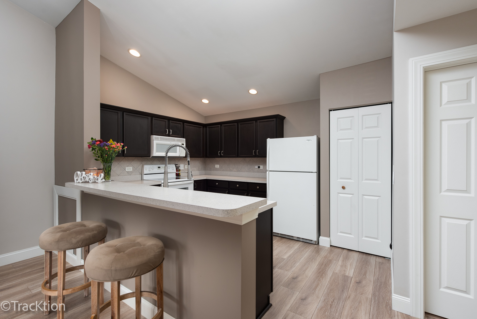 1610 McClure Road, Unit 1610 Aurora, IL 60505 - Photo 5 of 16 a kitchen with stainless steel appliances a sink a stove a refrigerator and cabinets