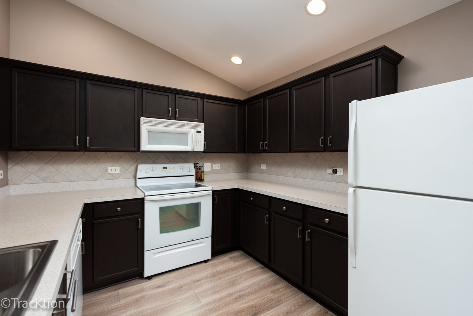 1610 McClure Road, Unit 1610 Aurora, IL 60505 - Photo 6 of 16 a kitchen with a sink and a refrigerator