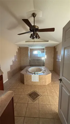 a bathroom with a granite countertop sink a mirror and shower