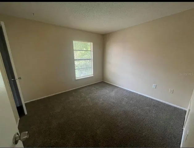 a bathroom with a granite countertop sink toilet a mirror and shower