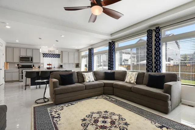 a kitchen with kitchen island granite countertop a table chairs sink and cabinets