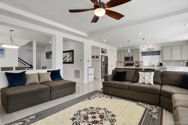 a kitchen with stainless steel appliances granite countertop a sink a stove and a refrigerator