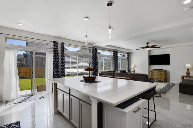 a kitchen with a dining table chairs refrigerator and cabinets