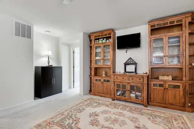 a view of walk in closet with clothes