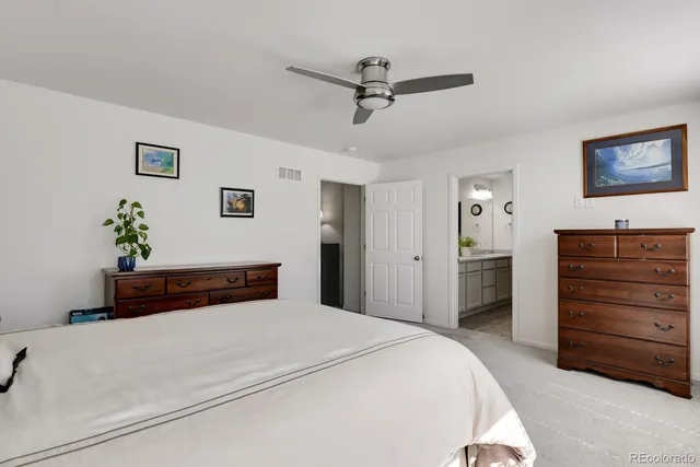 a living room with furniture a book shelf and a book shelf