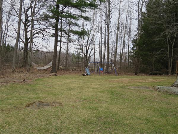 22 Lynch Road Wales, MA 01081 - Photo 4 of 11 a backyard of a house with lots of green space