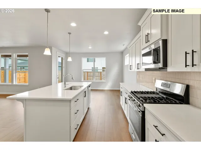 a kitchen with a sink stove and cabinets