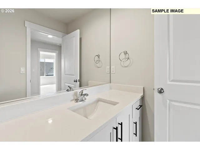 a bathroom with a sink vanity and a mirror