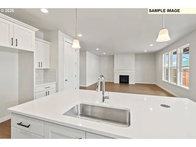 a kitchen with a sink a counter top space and stainless steel appliances